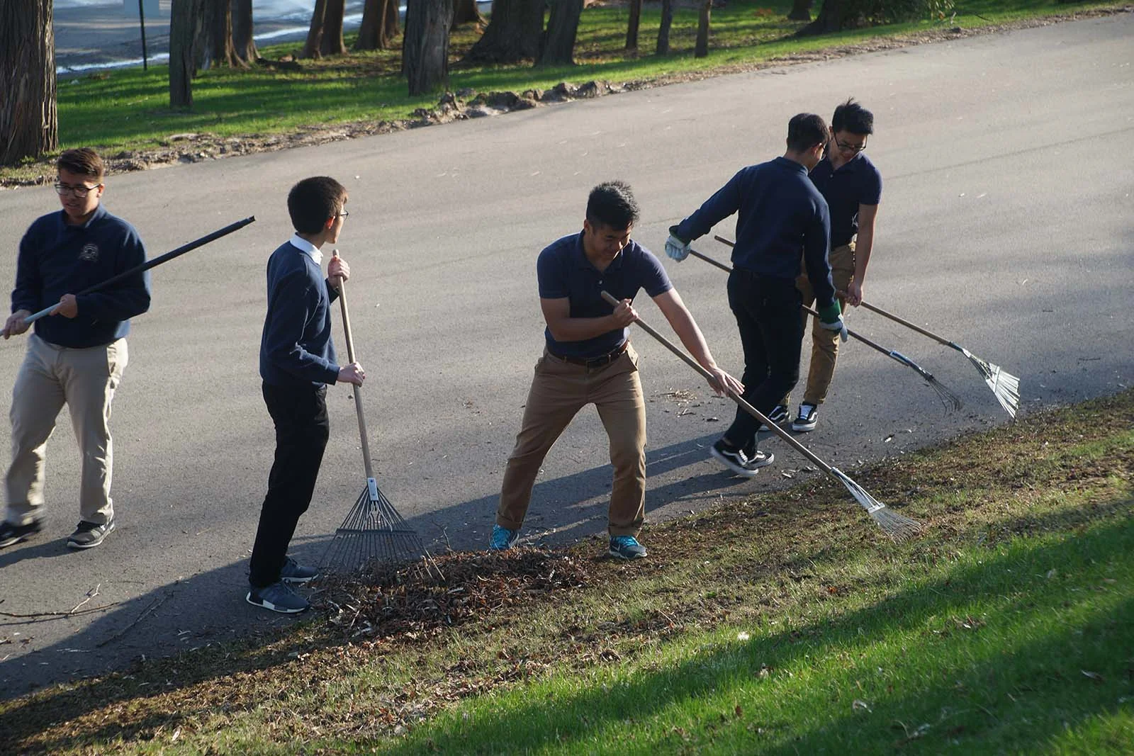 students raking leaves