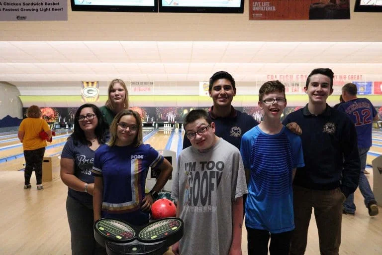 group smiling at bowling alley