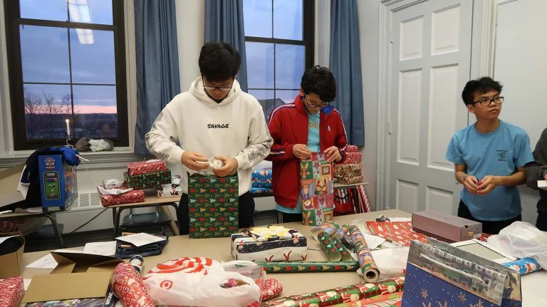 students wrapping christmas presents