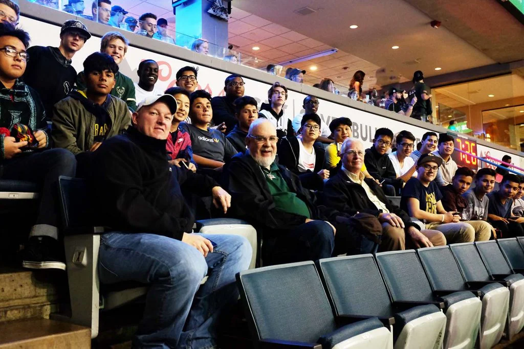 students and teachers in arena seats